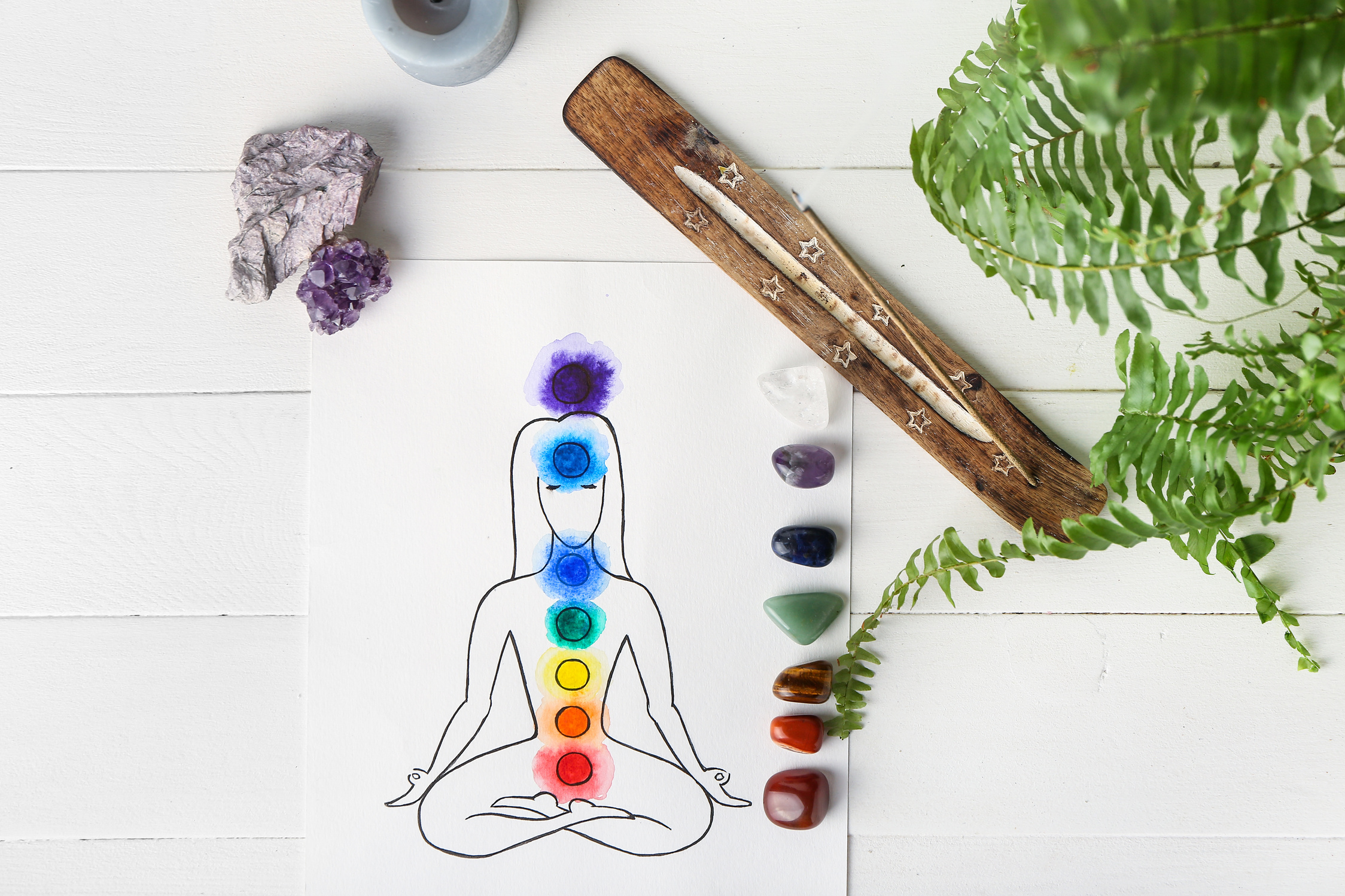 Drawing of Human, Set of Chakra Stones and Incense on White Background